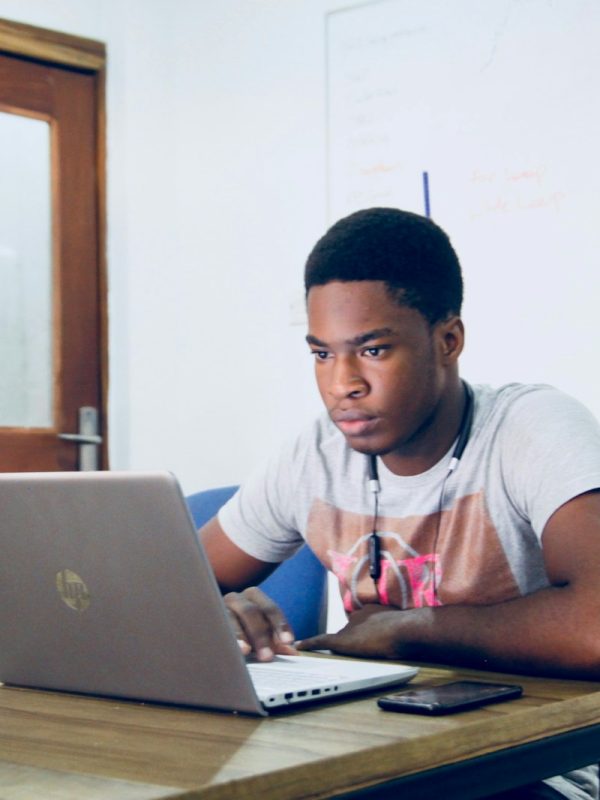 Photo by Desola Lanre-Ologun man in grey shirt using grey laptop computer