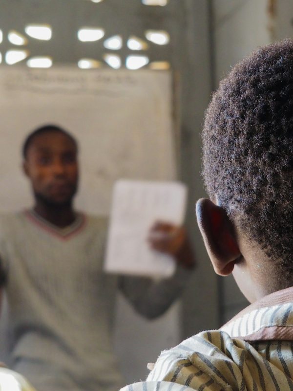 Photo by David Geneugelijk A teacher instructs students in a classroom.